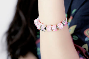 Pulseira de Contas/Charms Tons de Rosa com Flores e Coche com Cristais - REF1148 - PIME.pt